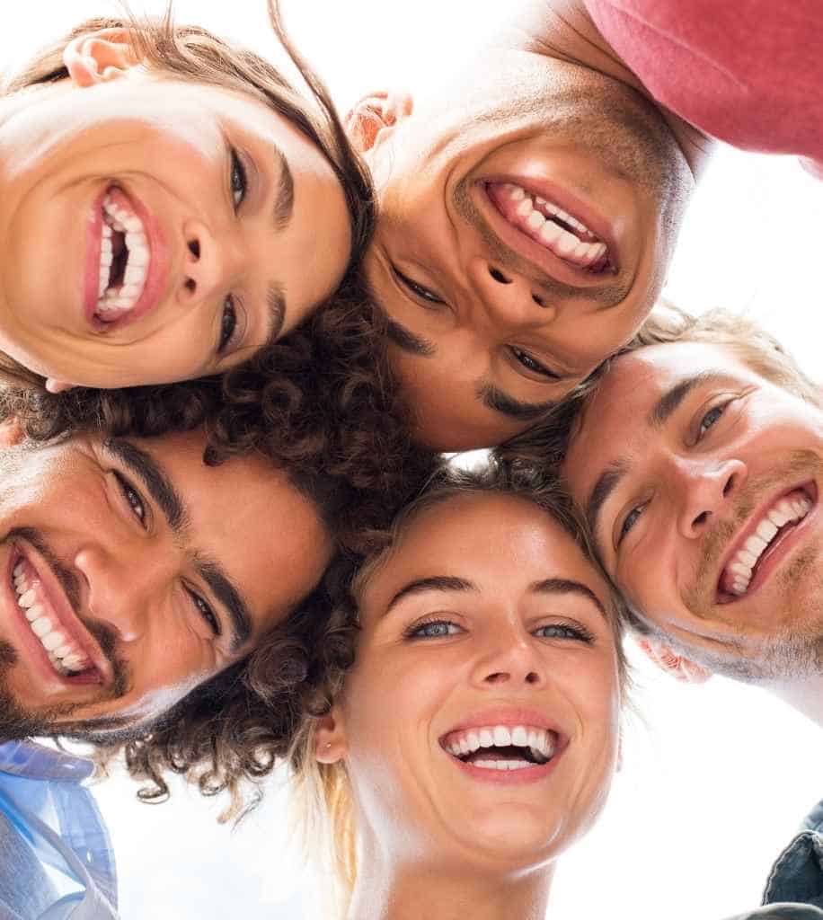 Smiling person showcasing white teeth after laser whitening treatment Hinckley
